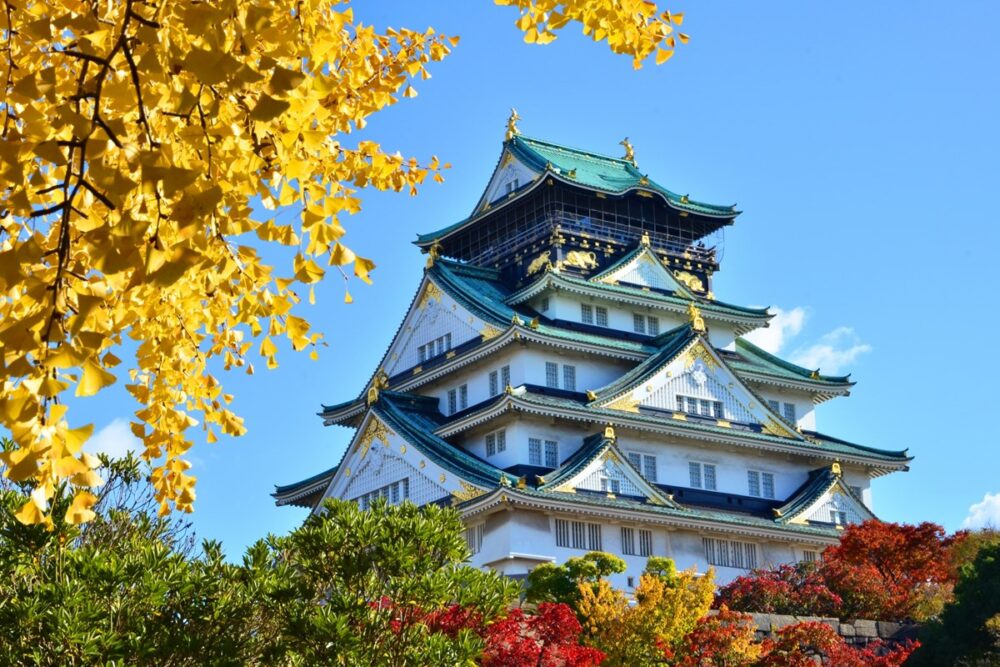 Osaka Castle's main tower surrounded by lush greenery