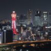 Illuminated Tsutenkaku Tower at night in Osaka